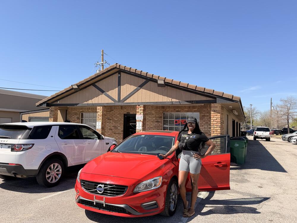 Roman Rentals customer picking up a red Volvo in Frisco